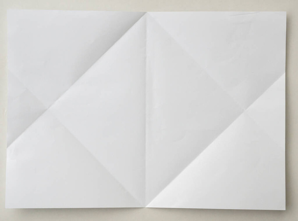 White folded and wrinkled paper on white background - Foto, Imagen