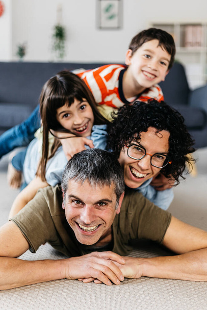 Vertical shot of happy family having fun together at home. - Φωτογραφία, εικόνα