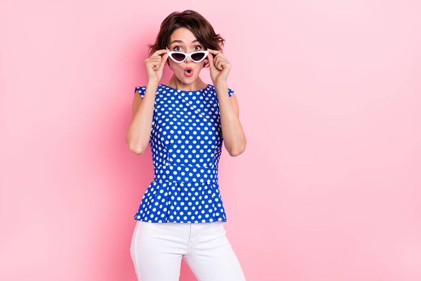 Photo of impressed millennial brunette lady open mouth wear glasses blouse jeans isolated on pink color background - Foto, Imagem