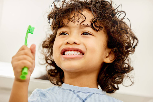 Smile, it lets your teeth breathe. Shot of a little boy brushing his teeth at home. - Φωτογραφία, εικόνα