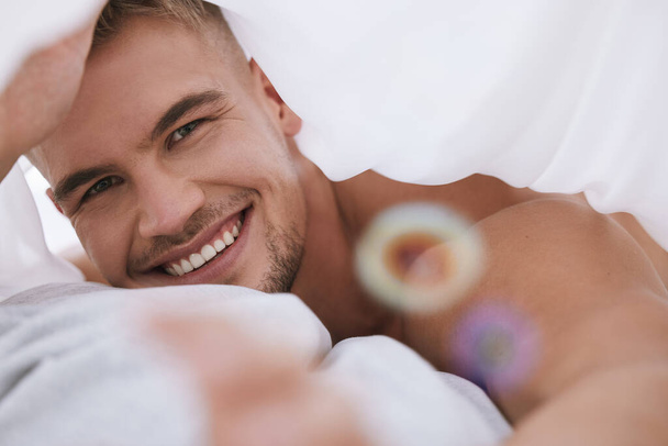 I just had the best dream. Cropped portrait of a handsome and muscular young man lying in his bed at home. - Valokuva, kuva