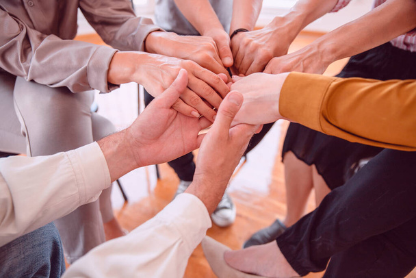 group of people holding hands together in the office - Photo, Image