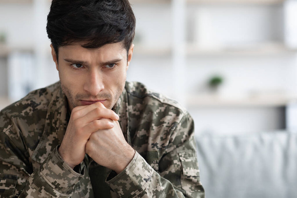 Thoughtful military guy staring at copy space - 写真・画像