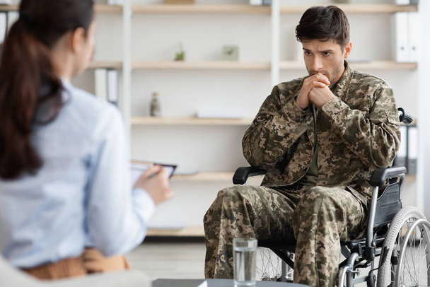 Απελπισμένος ανάπηρος στρατιώτης σε αναπηρική καρέκλα επισκέπτεται ψυχολόγο - Φωτογραφία, εικόνα