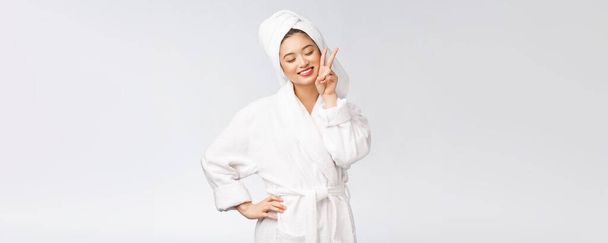 Mulher asiática bonita mostrando sinal de paz ou dois dedos com sentimento feliz. Isolado sobre fundo branco
. - Foto, Imagem