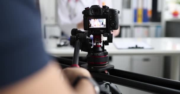 Videographer filming doctor on professional camera closeup 4k movie slow motion - Filmmaterial, Video
