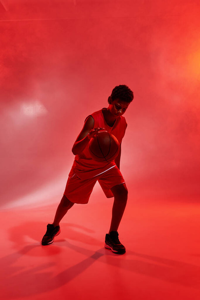 Boy basketball player dribble with ball in studio - Foto, imagen