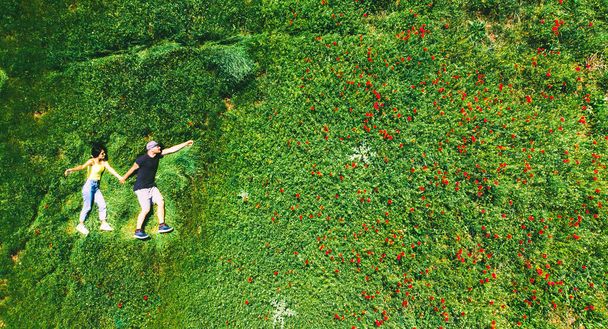 happy couple together in love isolated laying in green nature field on summer day. Top view fun in relationship couple copypaste background - Fotoğraf, Görsel
