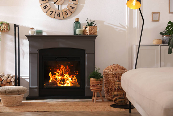 Stylish room interior with electric fireplace and beautiful decor elements - Zdjęcie, obraz