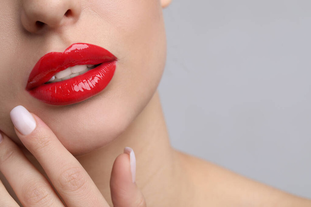 Young woman with perfect lips makeup on light background, closeup. Space for text - Fotoğraf, Görsel