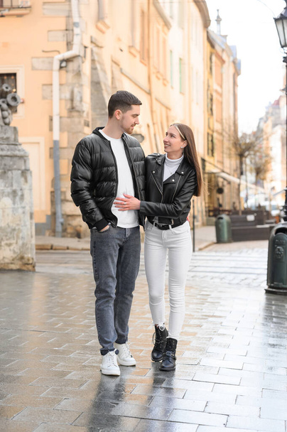Lovely young couple walking together on city street. Romantic date - Foto, Bild