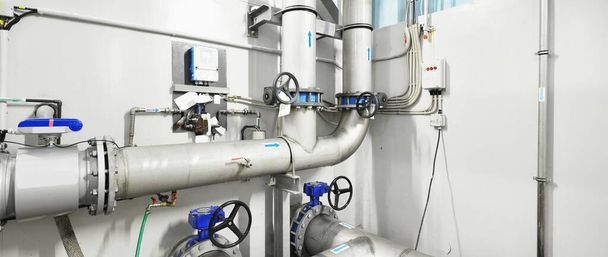 Large blue tanks in a industrial city water treatment boiler room. Wide angle perspective. Technology, chemistry, heating, work safety, supply, infrastructure - Foto, Imagen