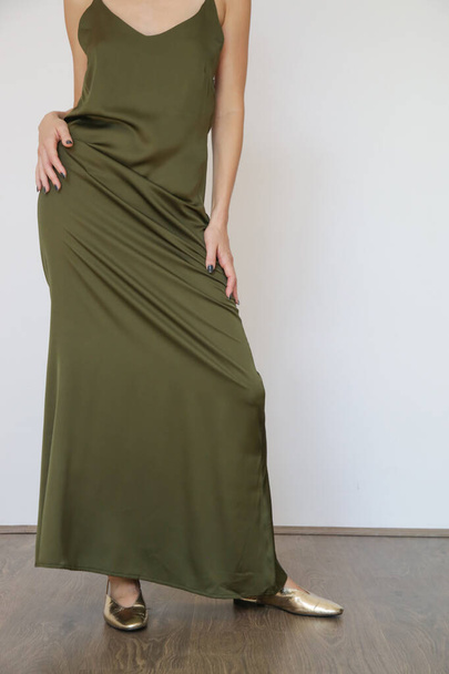Studio serie of imges of young woman in long green silk dress   - Fotó, kép