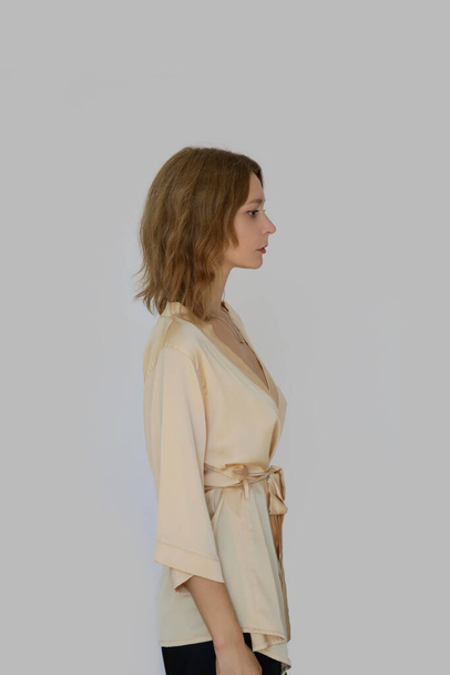 Studio serie of imges of young woman in beige silk robe - Fotografie, Obrázek