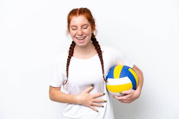 Young caucasian reddish woman playing volleyball isolated on white background smiling a lot - Foto, immagini