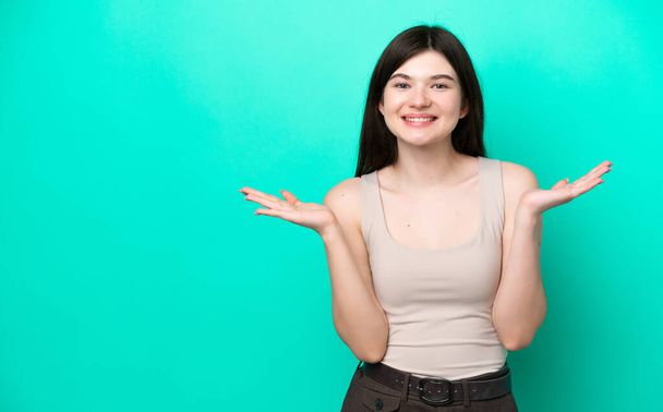 Young Russian woman isolated on green background with shocked facial expression - Foto, afbeelding