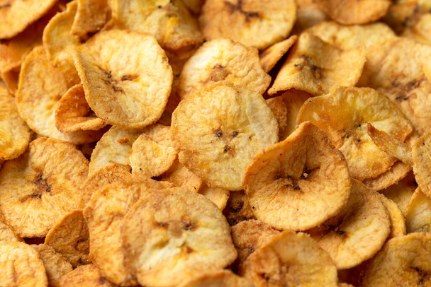 Sweet dried banana chips, snack background, texture - Zdjęcie, obraz