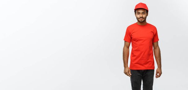 Delivery Concept - Handsome African American delivery man. Isolated on Grey studio Background. Copy Space. - Photo, Image