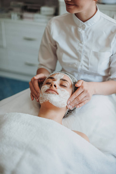 Face of woman in the spa salon getting a facial treatment. Girl facial treatment. Beauty skin. Beauty face. - Fotografie, Obrázek