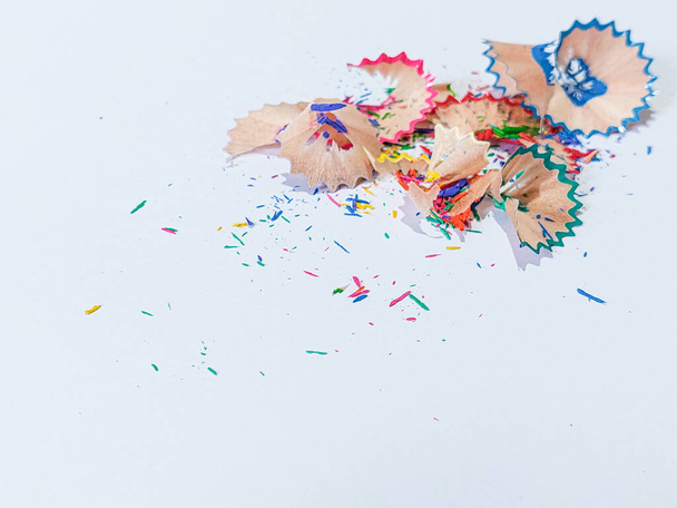 Wooden colored pencil sharpening shavings pile on white isolated background, top view, copy space, white space - 写真・画像