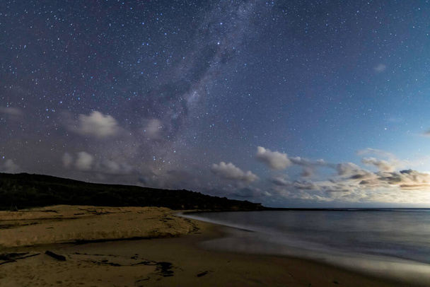 In the dark of the night at the beach under the Milky Way sky and stars at Putty Beach on the Central Coast of NSW, Australia. - Foto, immagini