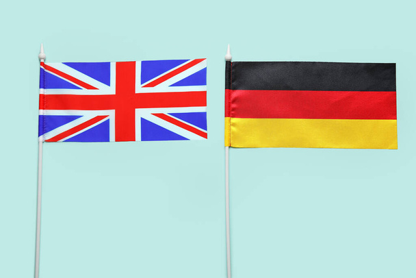 Flags of Germany and Great Britain on color background, closeup - Fotó, kép