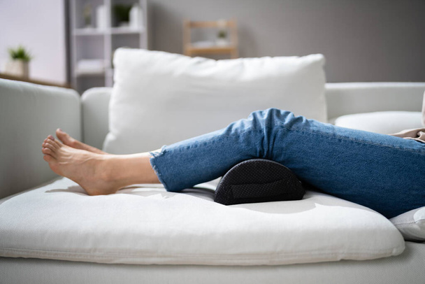Woman Using Footrest To Reduce Back Strain And Feet Fatigue - Zdjęcie, obraz