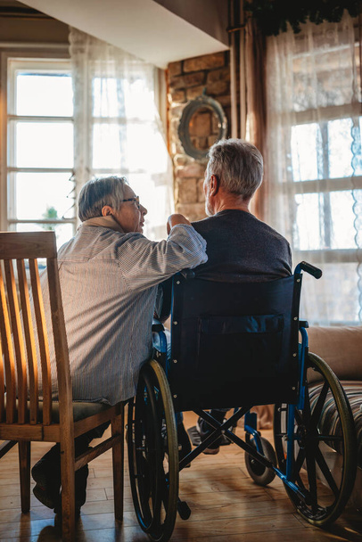 Couple of sad old people in love sitting together at home. Senior people healthcare love concept - 写真・画像