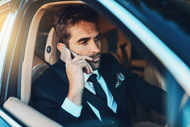 I cannot take this call, Im driving. Cropped shot of a handsome young corporate businessman on a call while commuting. - Фото, изображение
