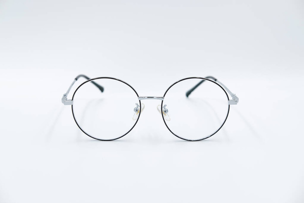 Isolierter weißer Hintergrund, selektive Fokussierung runde Brille mit silbernem Rand. - Foto, Bild