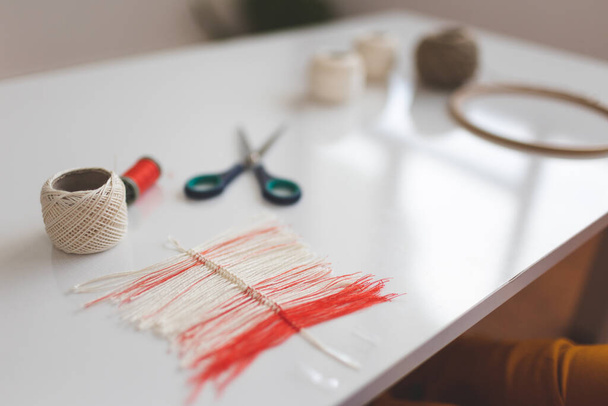 Thread Feather, DIY Home Decor, Handmade Yarn Decoration, Woman Making Dream Catcher Feather, Making a feather from thread, scissors on the table - 写真・画像