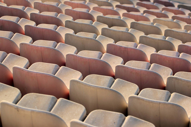 Rows of white plastic seats at a stadium - Fotó, kép