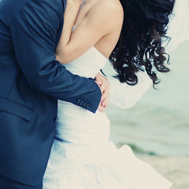 Beautiful bride and groom embracing. - Photo, Image
