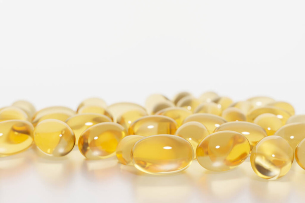 3d render of shiny orange capsules with fish oil or beauty serum for your project - 写真・画像
