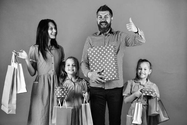 happy family go shopping. have a happy holidays. mother father and children prepare for celebration. big sale begin. black friday concept. family hold packages and presents - Φωτογραφία, εικόνα