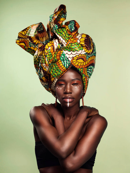 Life is beautiful and so are you. Studio shot of a beautiful young woman wearing a traditional African head wrap against a green background. - Foto, immagini