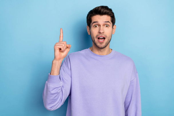 Photo of smart young brunet guy index up wear sweatshirt isolated on blue color background - Φωτογραφία, εικόνα