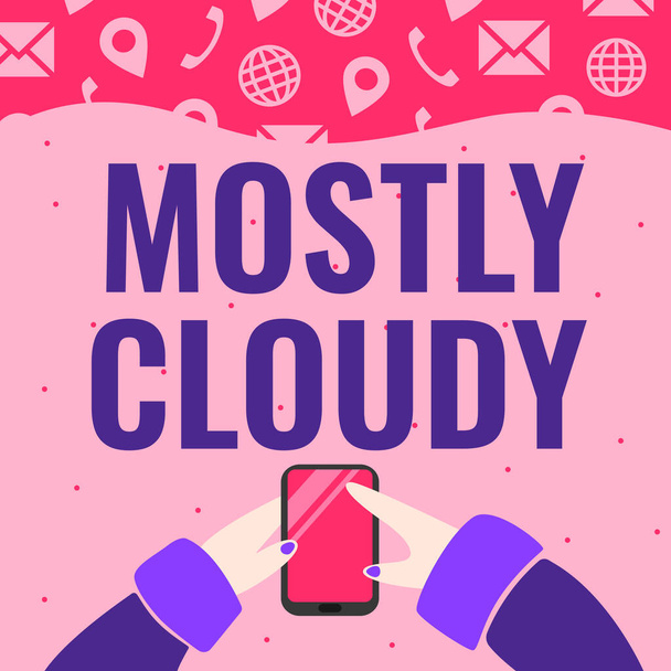 Sign displaying Mostly Cloudy. Business overview Shadowy Vaporous Foggy Fluffy Nebulous Clouds Skyscape Hand Holding Mobile Phone Pressing Application Button Showing Technology. - Foto, afbeelding