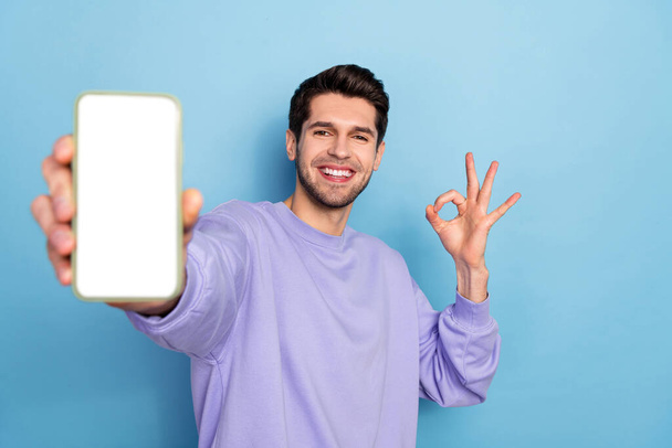 Photo of cool millennial brunet guy show telephone okey wear pullover isolated on blue color background - Φωτογραφία, εικόνα