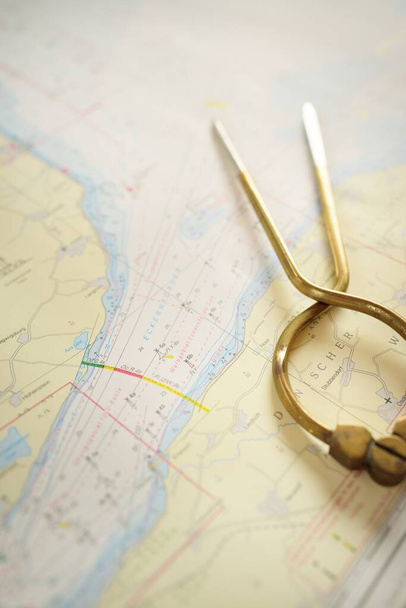 Antique W HC 6" brass dividers calipers nautical navigation chart tool and white map close-up. Vintage still life. Sailing, travel accessories. Planning, concept art, graphic resources, copy space - Photo, Image