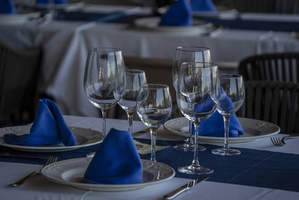 blue and white laden table of restaurant - Foto, Imagen