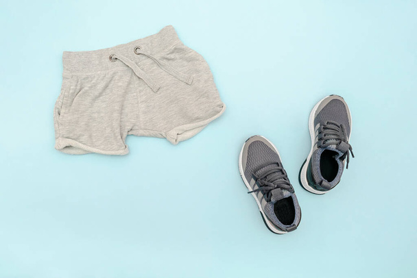 Summer babies blue clothes and accessories with gray shorts,sneakers. Modern fashion kids outfit.Set of childrens clothing for spring or summer. Flat lay, top view,overhead,mockup with copy space - Fotografie, Obrázek
