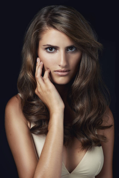 Luxurious hair. Studio shot of a gorgeous young model against a dark backdrop. - Zdjęcie, obraz