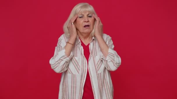 Senior woman rubbing temples to cure headache problem suffering from tension and migaine stress pain - Imágenes, Vídeo