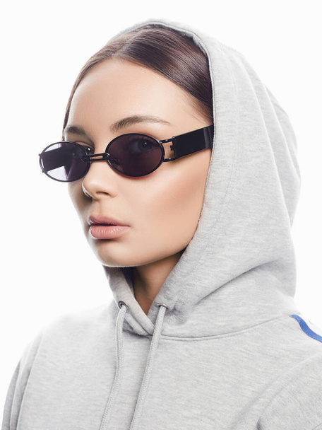 fashion portrait of Beautiful woman in sunglasses and hood. beauty girl in trendy Glasses - Zdjęcie, obraz