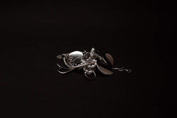 Jewelry made of silver, white gold lie on the background - Fotó, kép