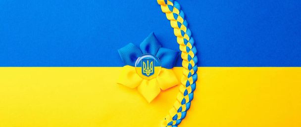Yellow blue background. Ukrainian flower trident symbol isolated on yellow blue flag banner. Support Ukraine concept - Foto, imagen