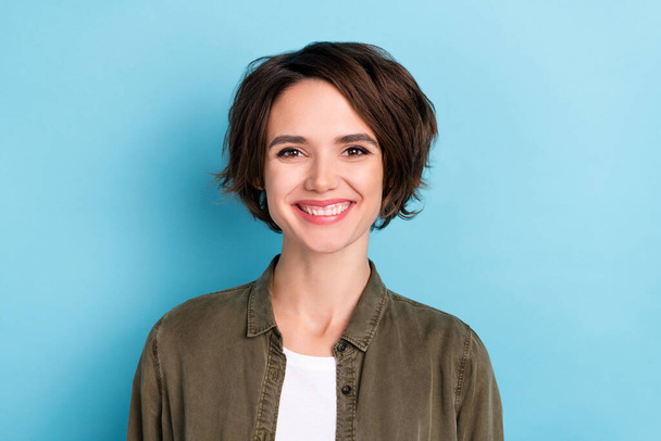Photo of funky young bob hairdo lady wear khaki shirt isolated on blue color background - Foto, imagen
