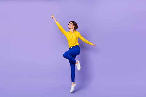 Full body photo of hooray young lady jump wear smart casual isolated on violet background - Foto, afbeelding