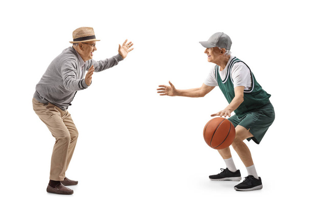 Full length profile shot of a seniors playing basketball isolated on white background - Fotó, kép